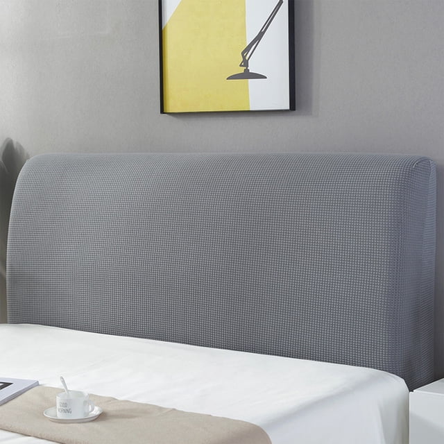 Headboard Covers Slipcover in grey, a resilient dust protector for upholstered headboards measuring 55.1-63 inches in length. Crafted from durable polyester with small embroideries and a textured check pattern, this slipcover is easy to install and machine washable. Ideal for flat or micro headboards, it preserves the headboard's condition while enhancing bedroom decor.