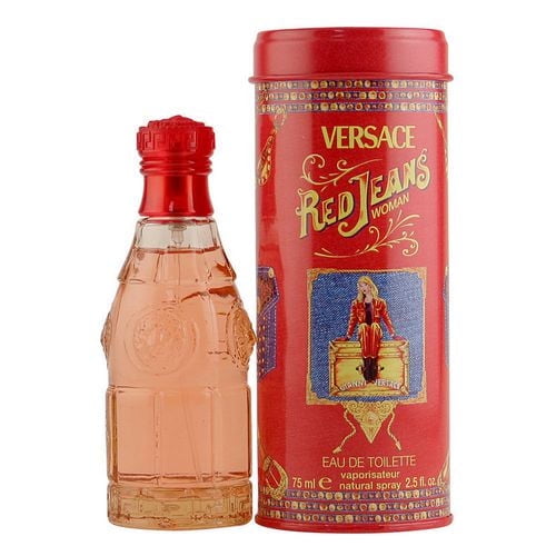 Red Jeans by Versace eau de toilette for women in a 75 ml clear glass bottle with embossed details and red cap, presented with a red cylindrical tin featuring vintage-style graphics and gold lettering, offering a casual scent blend of apricot, black currant, freesia, vanilla, and musk.