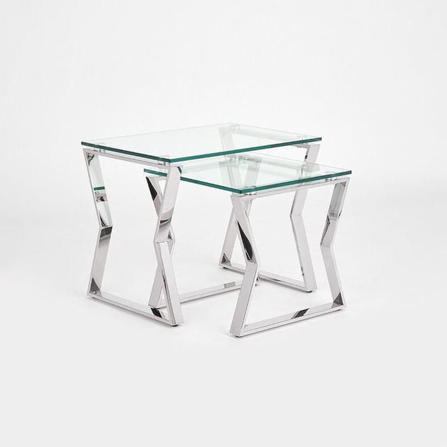 Home Gear Lily End Table set with two polished stainless steel nesting end tables featuring geometric angled legs and clear tempered glass tops, ideal for living room accent use and space-saving storage by nesting one table under the other.
