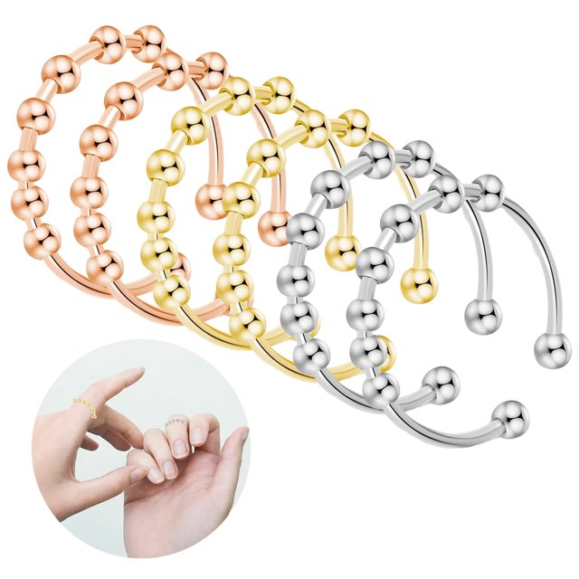 Ensemble de 6 Bagues contre l'Anxiété Comprenant des Bagues en Acier Inoxydable Ajustables en Argent, Or et Or rose. Chaque Bague Comprend 7 Perles Lisses Conçues pour Soulager le stress et Apaiser les Émotions. le design Ouvert Permet un Ajustement de la Taille, les Rendant Adaptées aux Hommes et aux Femmes. l'Ensemble Est Présenté avec les six Bagues Disposées en Dégradé de Couleurs, et une image en Encadré Montre les Bagues Portées sur les Doigts.