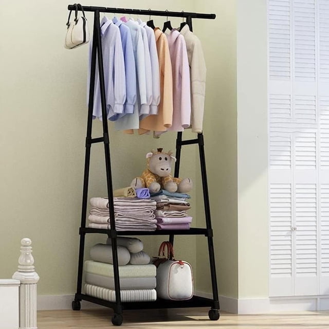 HueMaison Portable Garment Rack on Wheels Rolling Coat Racks with 2 Storage Shelves, Black. A free-standing black metal coat rack with a triangular frame, featuring a top bar for hanging clothes and two non-woven fabric shelves for storing folded items, shoes, or accessories. Equipped with 360° swivel wheels, two of which are lockable, for easy mobility. Compact dimensions of 22 inches long, 16.5 inches wide, and 63 inches high, with a weight capacity of 66 lbs when stationary. Ideal for bedrooms, closets, or laundry rooms.