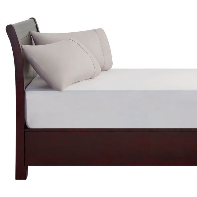 Mainstays Pillowcases in soft beige displayed on a dark wood sleigh bed with white fitted sheet, showing two standard-size 100% cotton pillowcases with 180 thread count, breathable and machine washable, suitable for refreshing bedroom décor and comfort.
