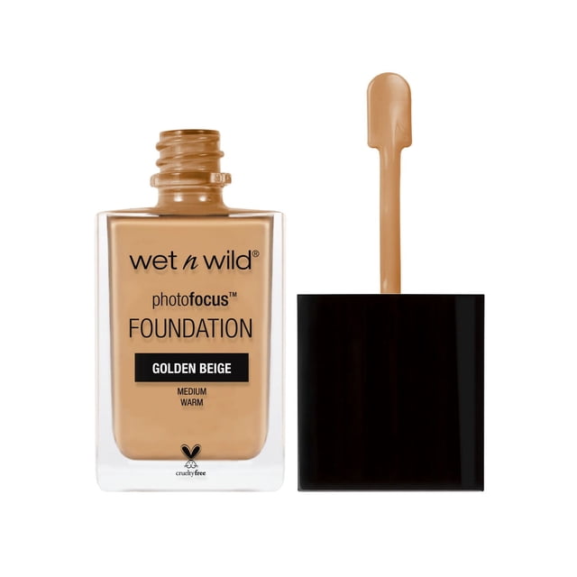 wet n wild Photo Focus Foundation in medium warm golden beige shade in a clear rectangular glass bottle with black text and an open black cap applicator wand showing liquid foundation, cruelty-free formula with matte, light-diffusing complex for flawless, camera-ready skin.