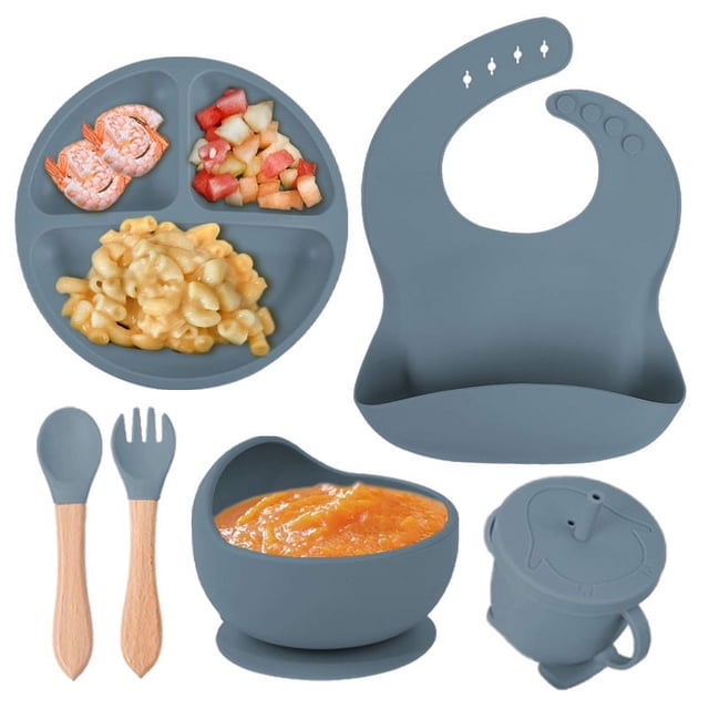 Children's complementary silicone plate baby complementary bowl smiley plate six-piece tableware set. This set includes a divided plate, a suction bowl, a bib with a food-catching pocket, a sippy cup with a lid, and a spoon and fork with wooden handles. Made from high-quality silicone, it is safe, durable, and lightweight, ideal for babies over 6 months old. The set features a cute design and is perfect for introducing solid foods during weaning. Shown in a muted blue color.