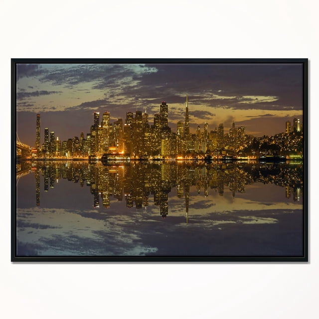 Design Art San Francisco at Sunset Panorama Framed Canvas Art Print featuring a panoramic view of San Francisco’s illuminated skyline at dusk reflected on calm water, printed with fade-resistant ink on premium canvas stretched over a 1-inch wood sub frame and enclosed in a black floating frame, ready to hang with included hardware, also suitable for enhancing modern home décor.