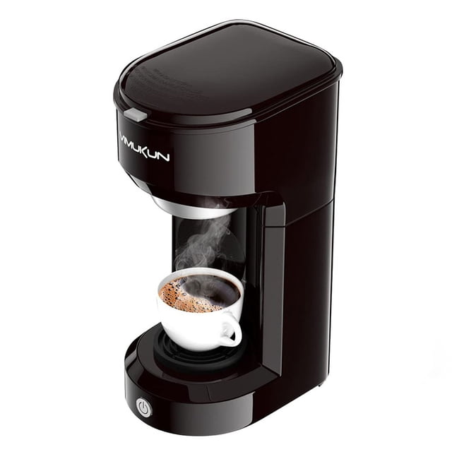 GRM Single Serve Coffee Maker compatible with K-Cup, shown in a compact black design with a steaming cup of coffee placed on the drip tray. This coffee maker supports both ground coffee and coffee pods, featuring a 6-14 oz water reservoir and automatic shut-off. Ideal for home, office, or travel use.