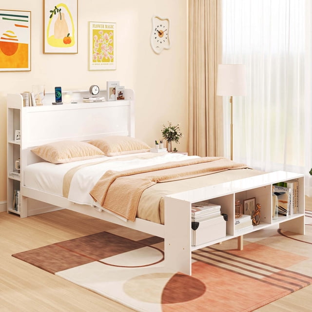 Costway Full Size Bed Frame with Storage Headboard & Footboard LED Bed Frame with 2 USB Ports in a modern bedroom setting. This white platform bed features integrated storage shelves in the headboard and footboard, ideal for books, decor, and essentials. Adjustable LED lighting with three colour options is embedded in the headboard, allowing for a customizable ambiance. Two USB ports on the headboard provide convenient charging for devices. The sturdy wooden construction includes plywood slats and five middle support legs for stability, with ample under-bed clearance for storage boxes or shoes. Perfect as a storage bed for organizing bedroom spaces.