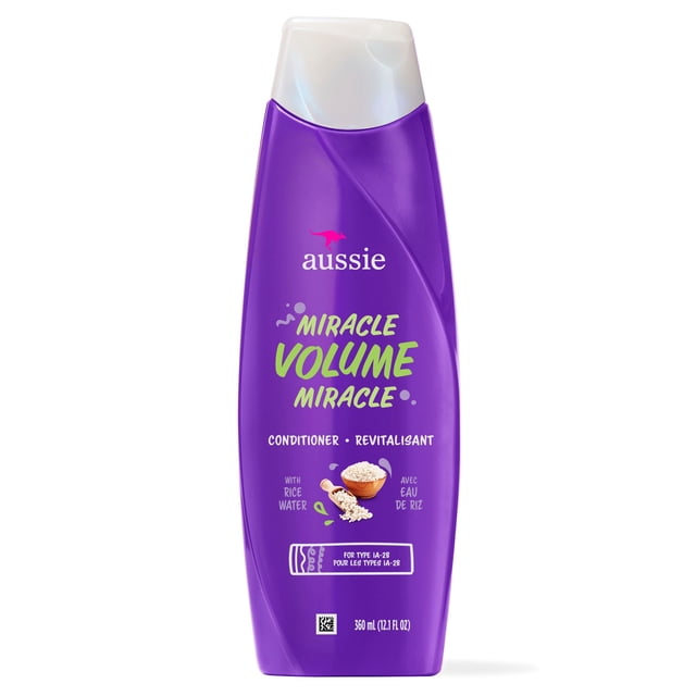 Aussie Paraben-Free Miracle Volume Conditioner w/ Plum & Bamboo for Fine Hair in a purple plastic bottle with a white flip cap, featuring rice water illustration and 360 ml (12.1 fl oz) volume, formulated to add volume and softness to flat hair.