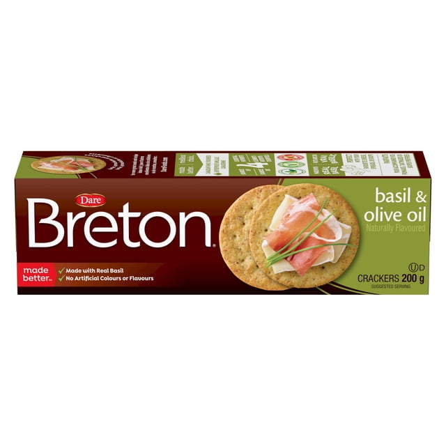 Breton Boîte de Craquelins Dare au Basilic et à l'Huile d'Olive avec Emballage Brun et Vert, Montrant Deux Craquelins Ronds de Blé Garnis de Fromage, de prosciutto et de Ciboulette. les Craquelins de 200 g Sont Faits avec du Vrai Basilic, Ne Contiennent Pas de Colorants Ni d'Arômes Artificiels, et Sont Aromatisés Naturellement, Convenant à la Collation Ou à Accompagner de Fromage et de Tartinades.