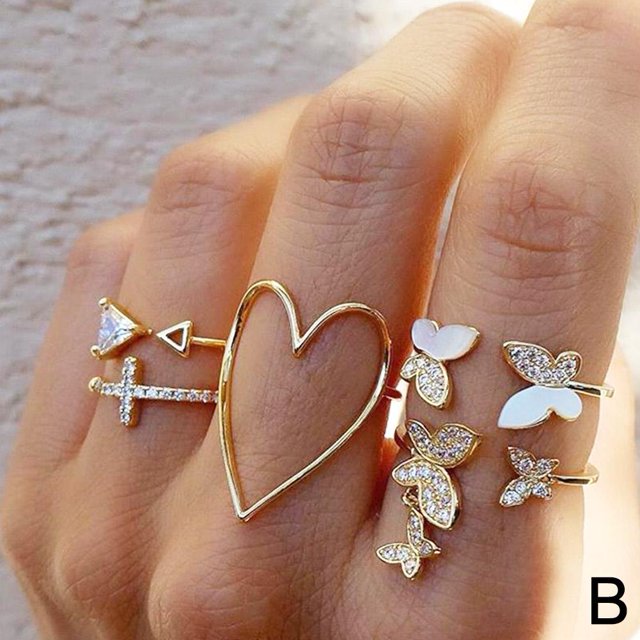 Bohemian Geometric Rings Knuckle Finger Rings Women S4 Fashion J3V7. A set of gold alloy knuckle rings featuring geometric and butterfly designs, including a heart-shaped ring, displayed on a hand. Ideal for women's jewelry collections and holiday parties.