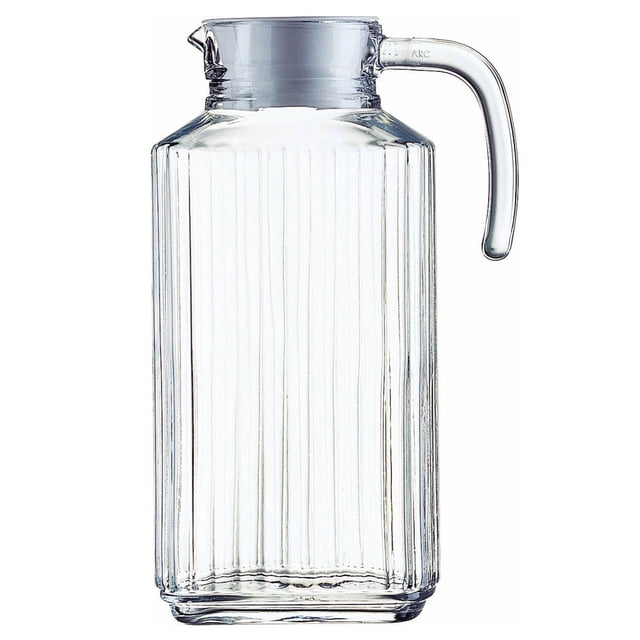 Trudeau Linea 1.8L Glass Pitcher with White Lid, clear ribbed glass jug with ergonomic handle and spout, topped with a white BPA-free plastic lid, compact design fits refrigerator door, dishwasher safe and ideal for serving beverages like juice or milk.