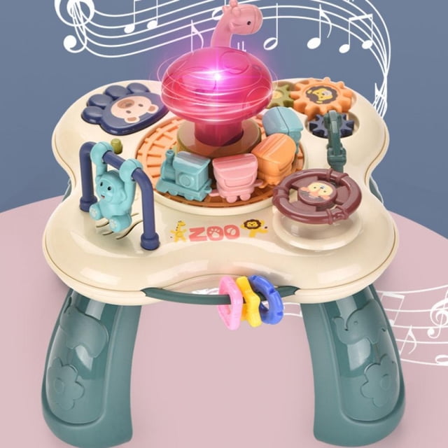 Baby Toys, Learning Musical Table designed for toddlers aged 1 to 3 years. This activity table features a rotating train with carriages, a light-up mushroom with sound effects, and colorful sensory activities. Ideal for skill development, hand-eye coordination, and cognitive growth. Cream-colored table with green legs and vibrant components.