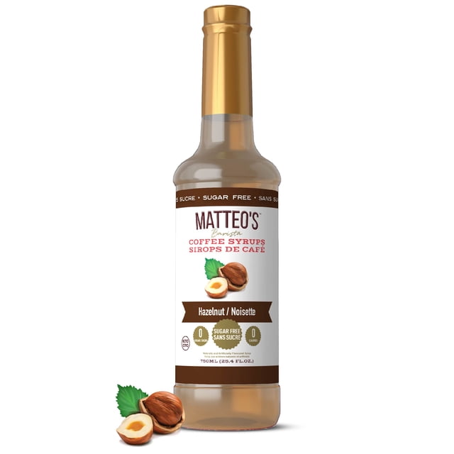 Matteo's Sugar Free Coffee Syrup, Hazelnut flavor, 750mL bottle with 0 calories and 0 sugar. The bottle features a golden cap and a label showcasing hazelnut imagery, bilingual text, and keto-friendly attributes. Ideal for enhancing coffee with a barista-inspired touch.
