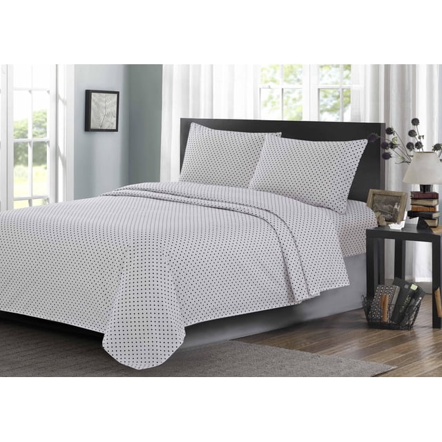 Johnson Home 200 TC Bed Sheet Set - Printed Cotton Sheets in white with small black polka dots, including two pillowcases and a flat sheet on a bed with a black headboard in a bright room with sheer curtains and wooden flooring, ideal for breathable, year-round comfort.