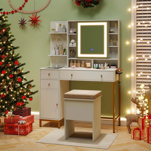 Costway Makeup Vanity Desk with Lighted Mirror Charging Station 3-Color LED Lights. This white and gold vanity set features a built-in charging station with 2 AC outlets, 1 USB port, and 1 Type-C port for convenient device charging. The HD LED lighted mirror offers 3 adjustable color settings—warm yellow, warm white, and cool white—controlled by a touch button. The desk includes ample storage with 8 open shelves, a mirrored cabinet, 2 small drawers, a large drawer with dividers, a side cabinet, and a hair dryer rack. The glass tabletop allows easy visibility of stored items. A matching padded stool is included. Displayed in a festive setting with holiday decorations.
