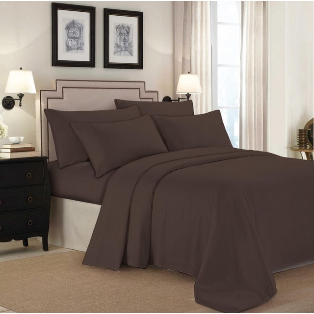 Johnson Home Huggable Jersey Knit Combed Cotton Easy Fit Sheet Set in dark brown on a bed with a beige upholstered headboard with nailhead trim, including fitted sheet, flat sheet, and pillowcases, in a softly lit bedroom with cream walls, framed architectural prints, wall lamps, and beige curtains.