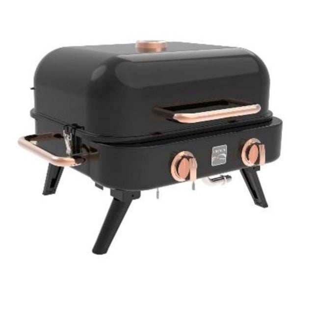 Kenmore 2 Burner Retro Tabletop Gas Grill in black and copper, front angled view showing two copper control knobs, copper lid handle, foldable black legs, and side handle, compact propane grill suitable for outdoor cooking and portable use.