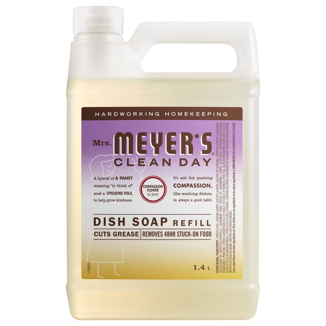 Mrs. Meyer's Clean Day Dish Refill Compassion Flower 1.4 L in a translucent plastic jug with white handle and cap, featuring a purple and beige label that highlights its biodegradable formula cutting grease and removing 48-hour stuck-on food, scented with a lightly sweet floral Compassion Flower fragrance, suitable for hand washing dishes, pots, and pans.
