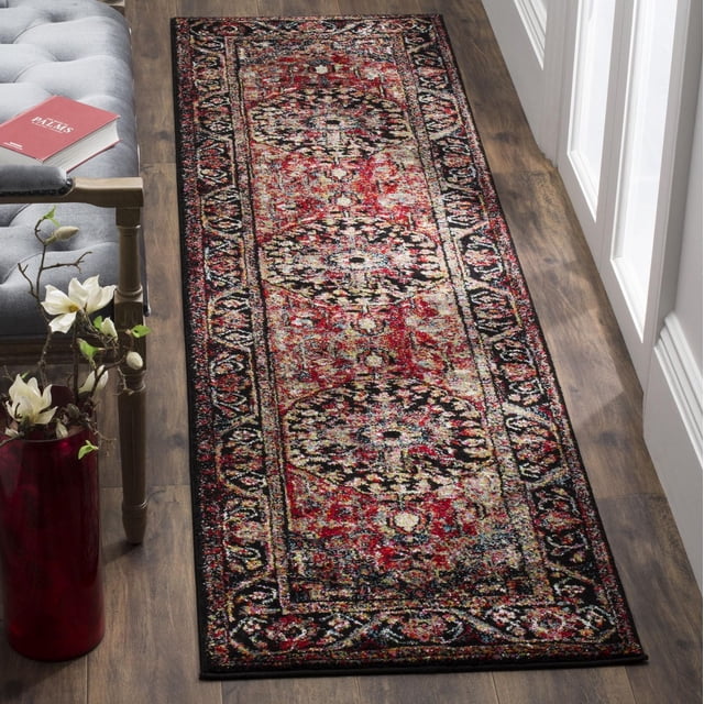Safavieh Vintage Hamadan Farran Traditional Area Rug runner featuring richly colored Persian-style motifs in red, black, and beige on hardwood flooring beside a gray tufted bench and red vase with white flowers, suitable for enhancing modern interiors with vintage appeal.