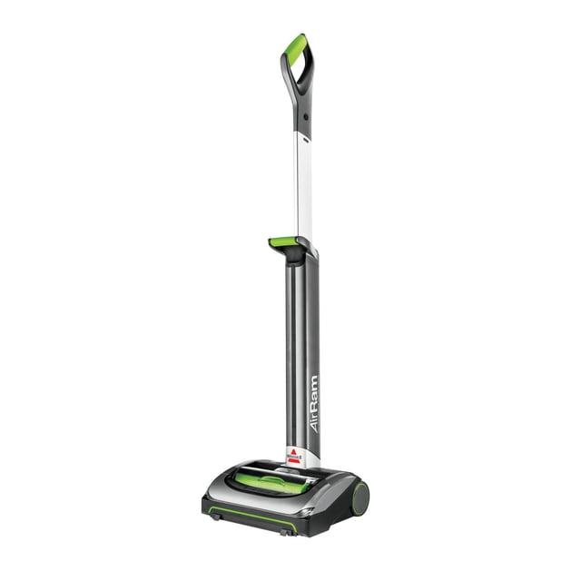 BISSELL® AirRam™ Cordless Stick Vacuum in grey with green handle grips, featuring a lightweight upright design with a slim white and grey shaft, large rear wheels, and a wide base with a visible green brush roll, ideal for cordless multi-surface cleaning including carpets and hard floors.