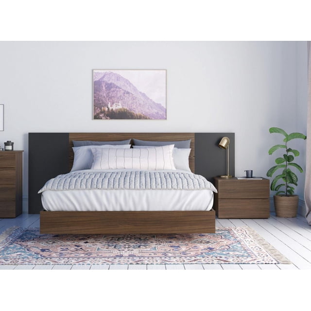 Dusk 4 Piece Bedroom Set with floating walnut and black bed featuring a rustic plank effect headboard and two matching two-drawer nightstands with metal slides, arranged on a patterned rug in a bright room with a potted plant and mountain wall art.
