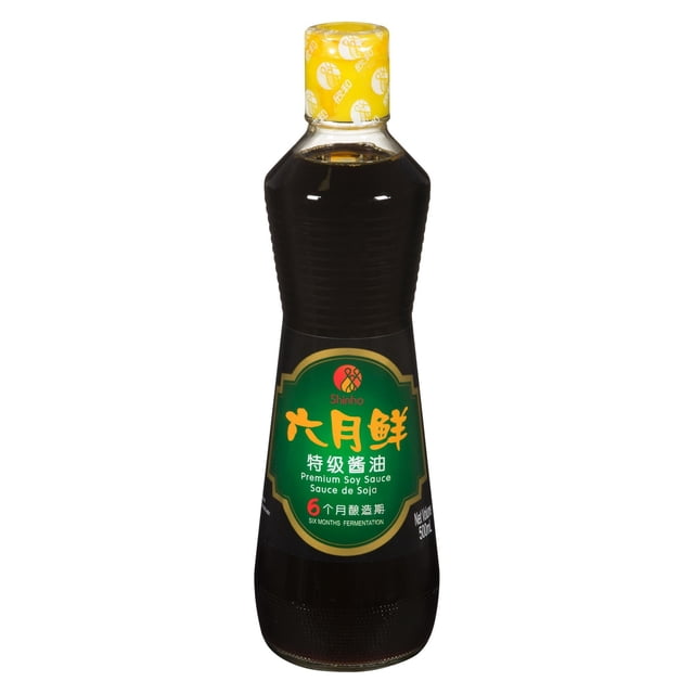 Shinho June Premium Soy Sauce 500 mL bottle with dark soy sauce, featuring a green label with yellow Chinese characters and English text indicating premium soy sauce and six months fermentation, sealed with a yellow cap, ideal for cooking or as dressing.
