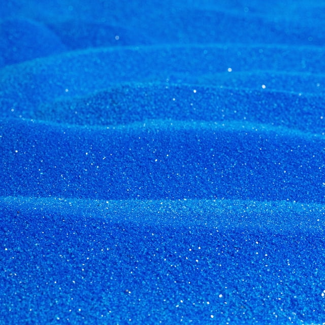 Sandtastik Classic Colored Sand in blue, shown in a close-up view highlighting its soft, naturally sparkling texture. The clean and uniform grain size ranges from 0.08mm to 0.425mm, making it ideal for craft projects, sand art bottles, vase fillers, and event decor. Certified non-toxic with no free silica, this 10 lb sand is inert and will not absorb foreign debris.
