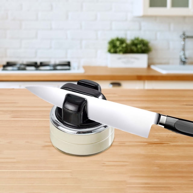 Professional Kitchen Knife Sharpener Tool with Strong Suction Base, ideal for home kitchens, displayed on a wooden countertop in a modern kitchen. This compact 2-in-1 tool sharpens both knives and scissors efficiently, featuring a stable suction base for safe use. Perfect for kitchenware and cutlery sharpening, it is easy to store in drawers or cabinets.