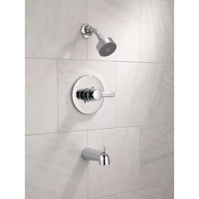 Peerless Tub and Shower Complete Rough and Trim in Chrome with chrome finish showerhead, single lever handle featuring pressure balance valve for temperature control, and tub spout mounted on white marble tile wall, suitable for budget-friendly bathroom renovations.