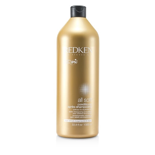Redken All Soft Conditioner for dry and brittle hair in a 1000ml (33.8oz) bottle. The gold-colored bottle features a black flip-top cap and branding details, including the Redken logo and product description. Designed to nourish and soften hair, it provides intense softness, movement, and shine while improving manageability.