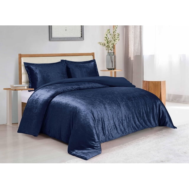 Swift Home Solid Crushed Velvet Duvet Cover Set in navy blue on a wooden bed with cream upholstered headboard, featuring soft crushed velvet fabric with subtle sheen and matching pillow shams, in a bright bedroom with light wood flooring, side table with books, and vase with white flowers, ideal for adding warmth and luxury to bedroom decor.