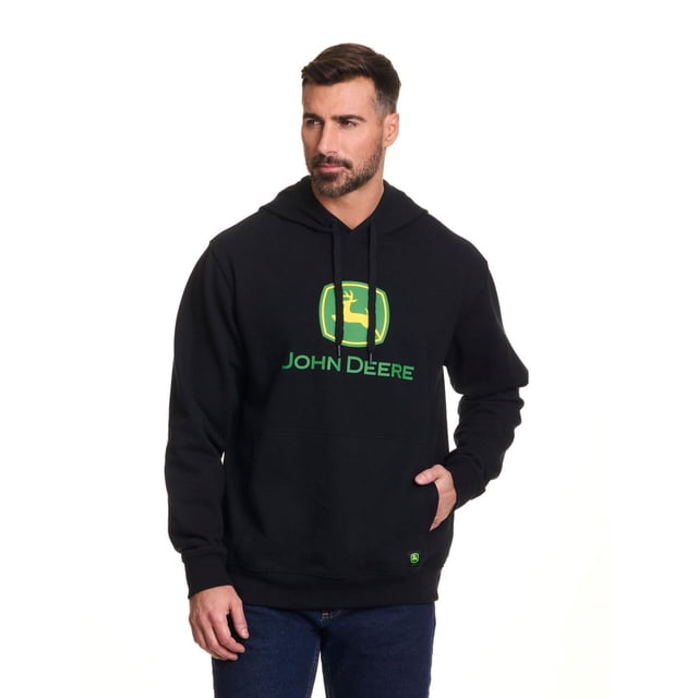 John Deere Men’s Core Logo Pullover Fleece Hoodie in black with green and yellow John Deere logo screen printed on the chest, featuring a front pouch pocket and adjustable drawcord hood with plastic tips, styled with blue jeans in a centered front view, suitable for casual wear or layering over a John Deere tee.