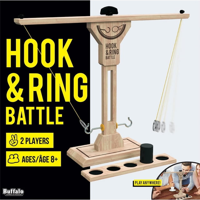 Buffalo Games - Hook & Ring Battle Game for Ages 8+ showing a wooden game with a vertical stand and horizontal arm holding two metal hooks and a swinging metal ring on a string. The base features a scoring ladder with five holes and a black peg for tracking points. Designed for two players, this fast-paced classic game is suitable for family and friends.