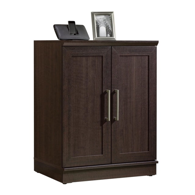 Sauder® HomePlus Collection Base Cabinet front-facing freestanding storage cabinet with framed panel doors, adjustable shelf behind doors, pre-attached decorative molding and adjustable base levelers, medium wood-tone finish in a neutral interior; suitable for storing linens or office supplies.