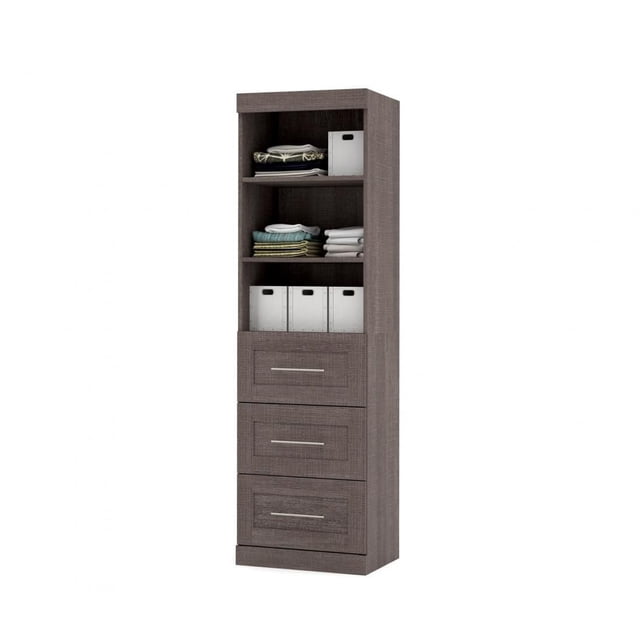 Pur by Bestar 25" storage unit with 3-drawer set in textured dark brown finish, featuring three ball-bearing slide drawers with metal handles and three adjustable shelves holding folded linens and storage bins, suitable for versatile home or office storage.