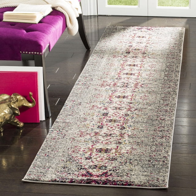 Safavieh Monaco Elsdon Abstract Area Rug runner with a power-loomed polypropylene weave, displaying a distressed abstract pattern in grey, pink, and cream hues, placed on dark hardwood flooring beside a purple tufted bench with a white knitted throw and an open book, ideal for adding Bohemian-chic style to hallways or entryways.