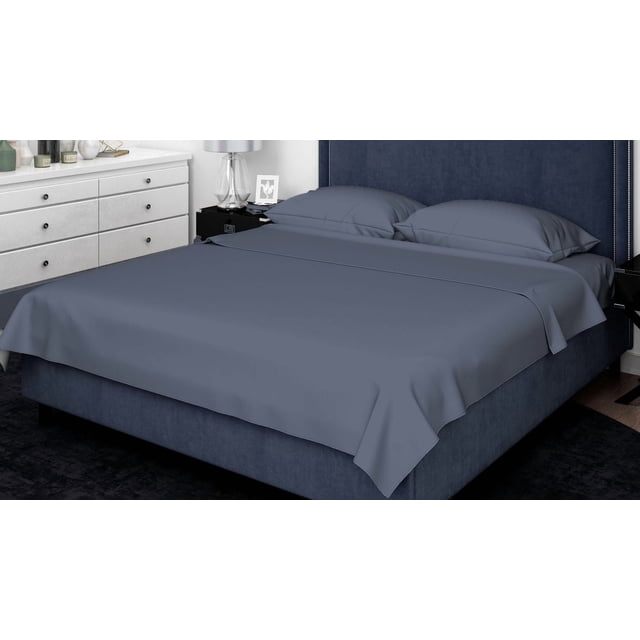 Johnson Home 500 Thread Count Certified Organic Cotton Sheet Sets in deep blue on a king-size bed with matching upholstered headboard. The breathable, hypoallergenic sheets include a flat sheet and two pillowcases made from smooth organic cotton. The set offers year-round comfort, easy machine washing, and suits various bedroom styles.