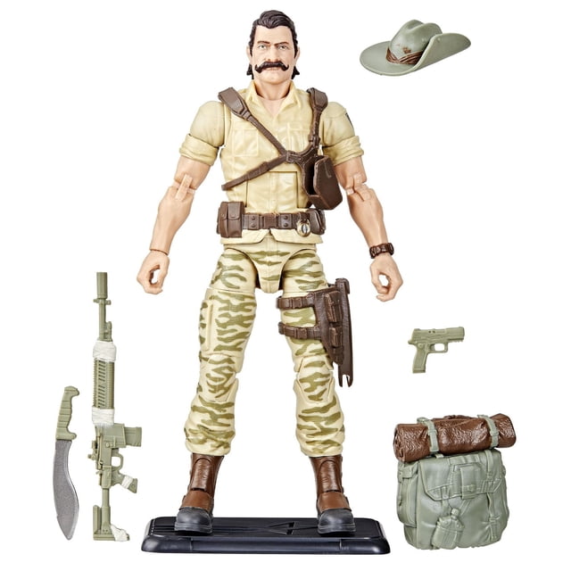 G.I. Joe Classified Series Retro Cardback Recondo action figure in tan jungle camo pants and beige shirt with brown boots and harness, displayed on a black stand with accessories including a green machete, rifle, pistol, slouch hat, and green backpack with rolled blanket.