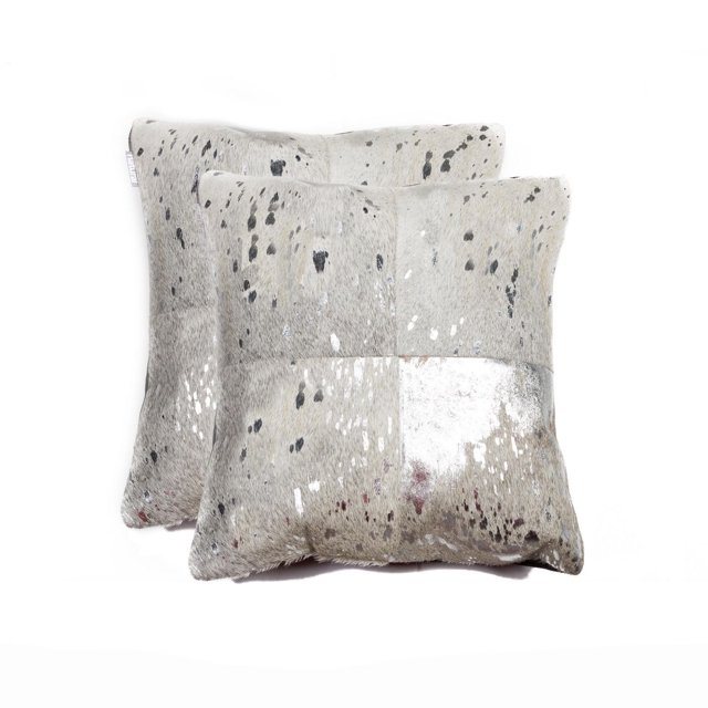 TORINO QUATTRO COWHIDE PILLOW 18"X18" 2-PACK with two square pillows crafted from 100% natural Indian cowhide featuring a patchwork of light grey and white panels with black and brown speckles. Each pillow has a soft microsuede backing, hand-stitched construction, and a hidden zipper closure for easy cleaning. These fade-resistant, shed-free decorative pillows add warmth and texture to home décor and are often used as floor cushions or layered accents on sofas and chairs.