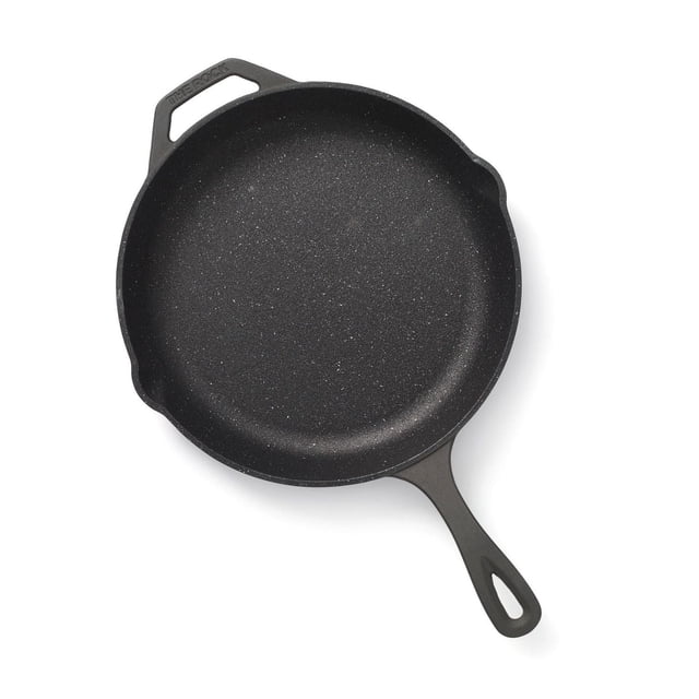 The Rock Cast Iron 12" (30cm) Skillet with a thick cast iron body and speckled black Rock.Tec non-stick surface, featuring integrated pouring spouts on both sides and a long handle with a hanging hole, shown from above on a white background. Oven safe up to 450°F and compatible with all stovetops.