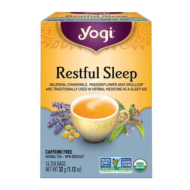 Yogi Teas - Restful Sleep Herbal Tea box with yellow and purple design, featuring a cup of amber tea and illustrations of valerian, chamomile, passionflower, and skullcap herbs, labeled caffeine-free, USDA organic, and Non-GMO Project verified, containing 16 tea bags weighing 32 grams (1.12 oz), suitable for calming and sleep support.