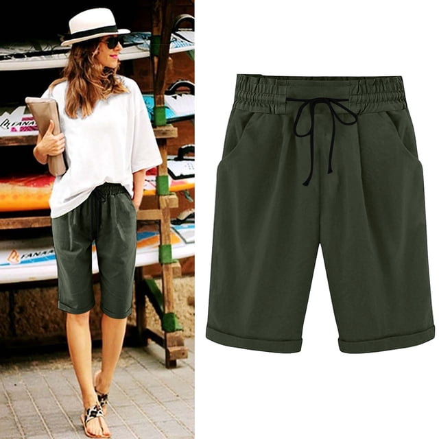 DPTALR Women's Summer Elastic Waist Drawstring Side Pocket Solid Color Short Pants 5/4 in dark green. These women's casual shorts feature an elastic waistband with a black drawstring, side pockets, and a relaxed fit, ideal for summer wear. Displayed alongside a lifestyle image of a woman pairing the shorts with a white oversized top and sandals in a casual outdoor setting.