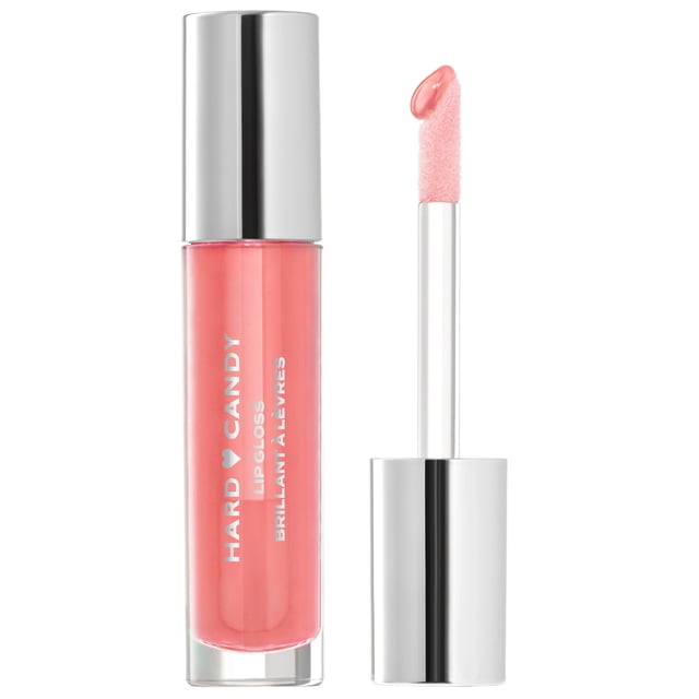 Hard Candy Glosstopia Lip Gloss in a clear tube with silver cap, showing coral pink gloss. The applicator wand with angled soft tip holds a drop of hydrating, high-shine lip gloss. The tube displays white Hard Candy branding. Suitable for quick, non-sticky lip hydration.