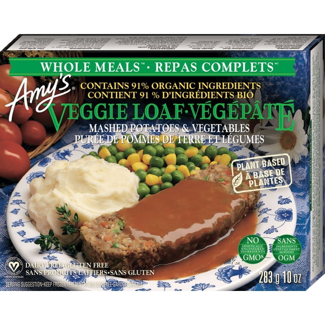 Amy's Kitchen Veggie Loaf Whole Meal featuring a plant-based veggie loaf slice covered in tomato-based gravy, served with organic mashed potatoes, green peas, and golden corn on a blue and white floral plate, containing 91% organic ingredients, dairy-free, gluten-free, and non-GMO in a 283g frozen meal.