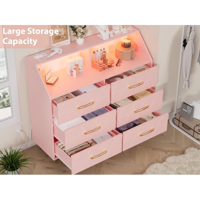 Modern 6 Drawer Dresser with Charging Station & RGB LED Lights by TROPOW, crafted from engineered wood with gold handles and supported by sturdy metal legs. The 47-inch dresser features geometric drawer fronts, a top shelf with customizable LED lighting, and built-in outlets and USB ports for charging devices. Ideal for bedrooms, nurseries, or apartments.