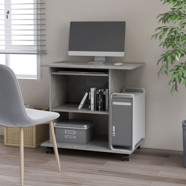 vidaXL Computer Desk in concrete grey, measuring 80x50x75 cm, made of engineered wood. The desk features a pull-out keyboard tray, a dedicated CPU tower shelf, and two additional shelves for storage. It is equipped with castors for mobility and is shown in a modern office setting with a desktop computer, books, and storage boxes placed on the desk. A grey chair and a potted plant are visible in the background.