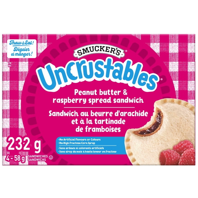 Smucker's Uncrustables Peanut Butter & Raspberry Spread Sandwich frozen pack of 4, 232 g total, showing a bitten sandwich with creamy peanut butter and smooth seedless raspberry spread inside soft white bread, in a pink and white checkered box with bilingual English and French text stating no artificial flavours or colours and no high fructose corn syrup, ideal for thaw and eat convenience.