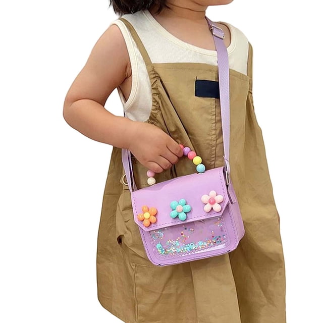 Ediodpoh Kids Cute Messenger Bag Floral Crossbody Small Shoulder Purse for Girls in a lightweight purple design. The bag features a floral pattern with colorful 3D flower embellishments on the flap and a beaded handle. It is shown being worn by a child, paired with a casual outfit. Compact and practical, it is ideal for daily use, casual outings, or travel.