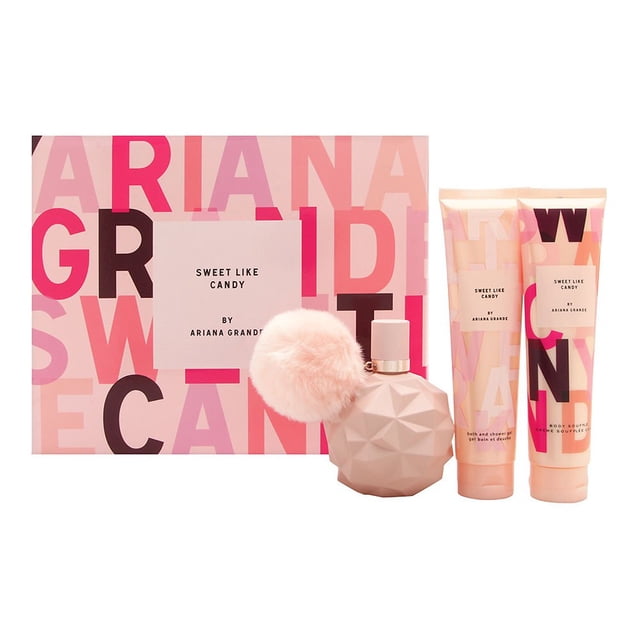 Sweet Like Candy By Ariana Grande 3 Piece Gift Set featuring a 3.4 oz Eau De Parfum spray, 3.4 oz body lotion, and 3.4 oz bath and shower gel. The set includes a bubblegum pink studded perfume bottle with a fluffy puff attached to the stopper, alongside matching pink-themed packaging with bold text design. Ideal for women who enjoy light, sweet gourmand fragrances with notes of bergamot, marshmallow, and vanilla.
