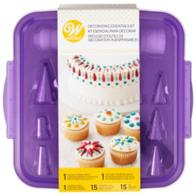 Wilton Decorating Essentials Kit, 33-Piece centered product shot of an open clear storage box containing assorted metal and nylon piping tips, visible couplers, two reusable piping bags and decorating tools for piping buttercream on cakes, cookies and cupcakes; often used for detailed borders and lettering.
